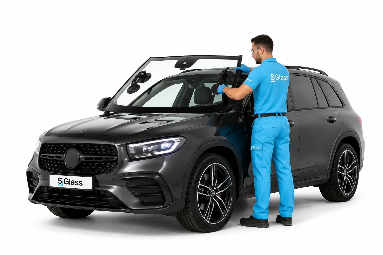 technicien qui remplace un pare-brise